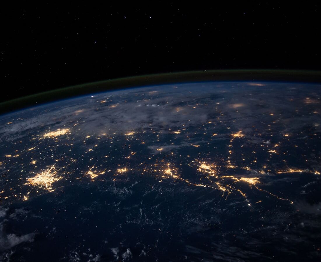 The earth at night, city lights picking out the coastlines of Europe.